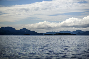 Fjords landscape with clouds in the sky, sunny day in summer