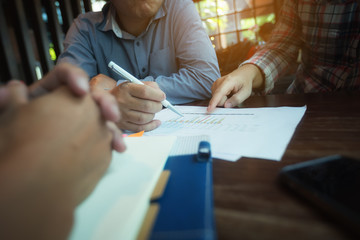 A picture of a businessman sitting in a meeting planning a collaboration.
