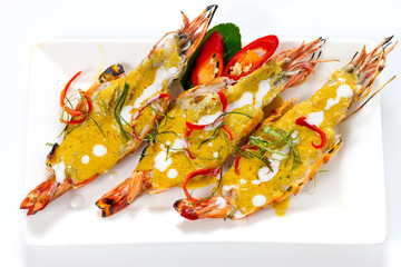 Three Pieces of Jumbo Shrimps with Panang Curry Thai Style on White Porcelain Square Plate, Isolated on White Background with Shadow. Macro Close-up High Angle Top View, Selective Focus at Food.