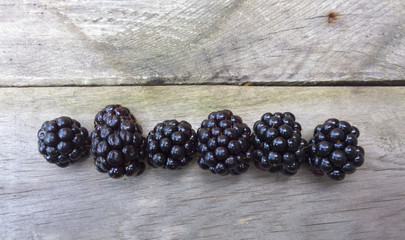 Blackberry on wooden background. Black berry on board texture