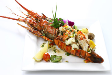 Stir-fried Lobster with Garlic & Butter Sauce on white square porcelain plate Isolated on white background with shadow High angle Back Side view, Luxury Seafood. Selective Focus at Meat