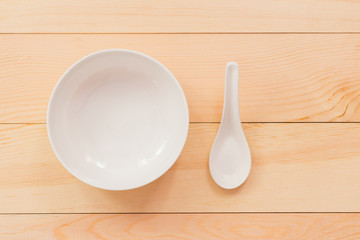 Empty white bowl on wood desk,Top view