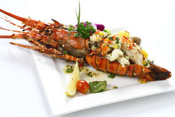 Stir-fried Lobster with Garlic & Butter Sauce on white square porcelain plate Isolated on white background with shadow Top Side view, Seafood.