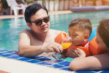 The little boy relax by swimming in the pool.