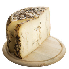 Loaf of cheese with truffles isolated on a wooden plate