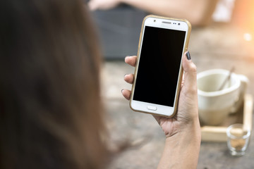 Close-up Of Young  female Playing Video Game On Mobile