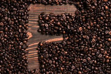 Letter F inscription with coffee bean on the wooden table
