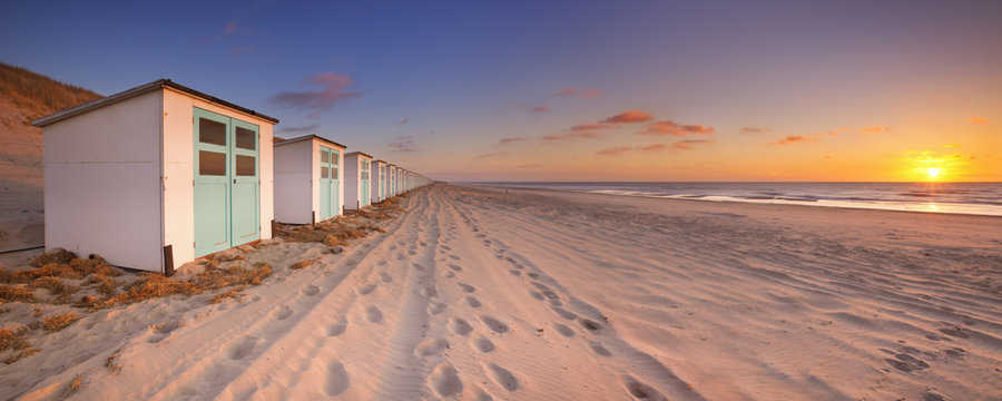 Row of beach huts at sunset, Texel island, The Netherlands