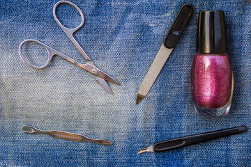 Basic set of manicure tools on jeans background