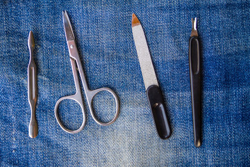 Basic set of manicure tools on jeans background
