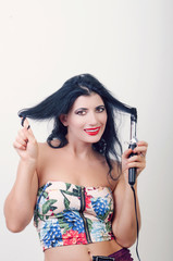 Fototapeta premium girl with the rectifier of hair