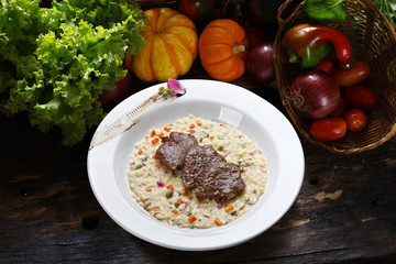 Risotto with vegetables and grilled steak