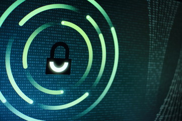 photo of computer screen display with black graphic lock symbol. binary numbers background. computer data protection. Internet Business Cyber security system concept