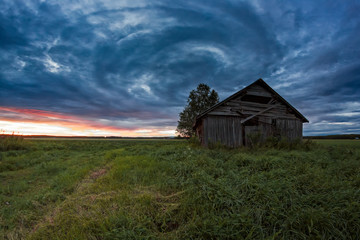 Fototapeta premium Circle Of Clouds Over The Old Barn House