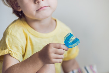 Three-year old boy shows myofunctional trainer to illuminate mouth breathing habit. Helps equalize...