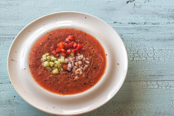 Portion of gazpacho on the wooden table