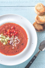 Portion of gazpacho on the wooden table