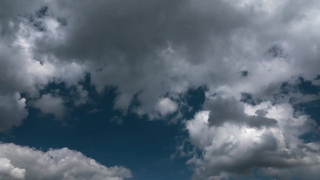 time lapse clip of white fluffy clouds over blue sky