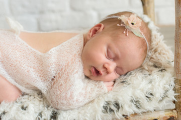 newborn baby girl sleeping in a beautiful pose