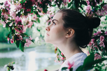 Girl near blossoming tree.