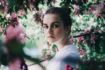 Girl near blossoming tree.