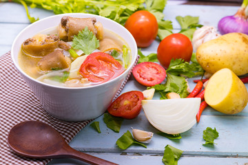 Oxtail soup in white dish on blue  table, Delicious halal food
