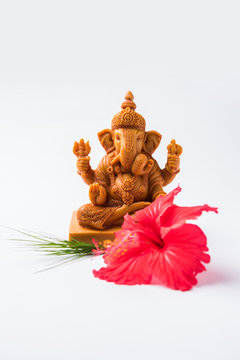Happy Ganesh Chaturthi Greeting Card showing photograph of lord ganesha idol, pooja or puja thali, bundi laddu/modak, durva and hibiscus or jasvand flower
