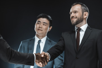 multiethnic business partners shaking hands