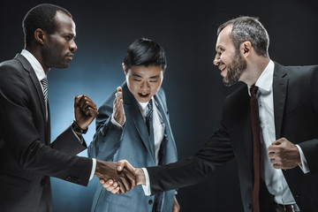 multiethnic business partners shaking hands
