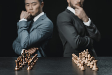 multiethnic businessmen looking at chess