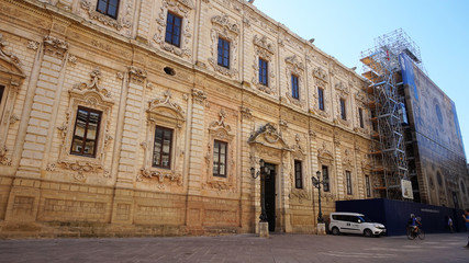 Fototapeta na wymiar LECCE, ITALY - AUGUST 2, 2017: Celestini Palace with Basilica di Santa Croce in renovation, Lecce, Italy