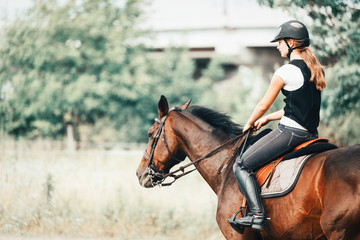 Picture of young girl riding her horse