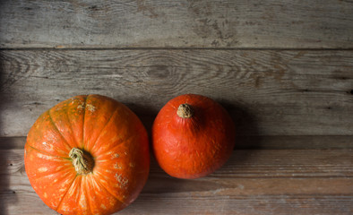 Organic ogange pumpkins on wooden table, thanksgiving pumpkin background, autumn harvest