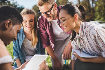 multiethnic students with digital tablet