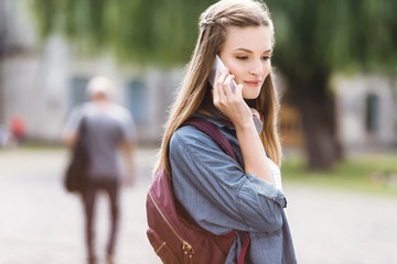 girl talking by phone in park