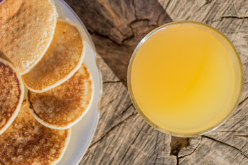 Breakfast with pancakes and orange juice on a wooden table
