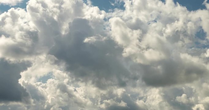 Time lapse clip of white fluffy curly rolling clouds