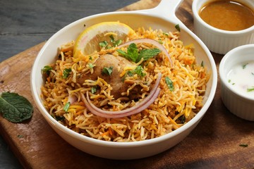 Hyderabadi Chicken Biryani served with Yogurt raita and Salan