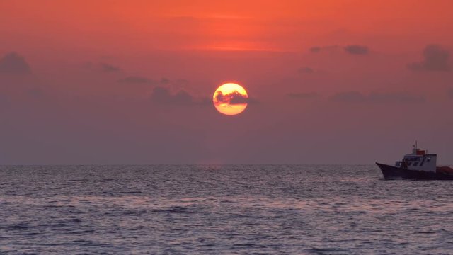 Sunset with sun down and view on luxury yacht crusing at the sea. Vacation around the world. Travel destinations. Nobody