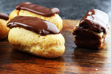 Traditional French dessert. Eclair with chocolate icing. Pastery concept