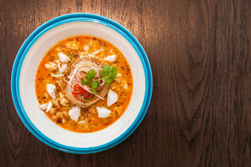 A bowl of Crab meat curry with vermicelli, Crab meat Laksa on wood table