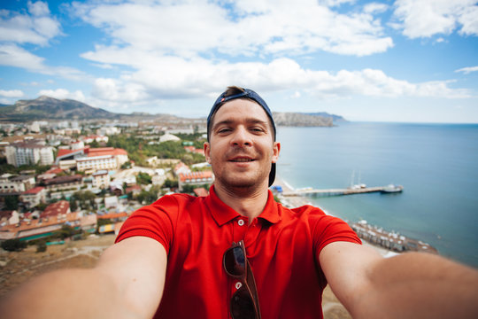Handsome guy making selfie Sudak in the mountains, Russia