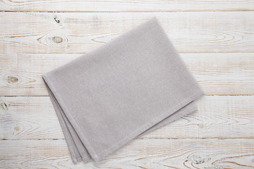 Napkin white. Stack of grey dish towels on white wooden table background top view, mock up.