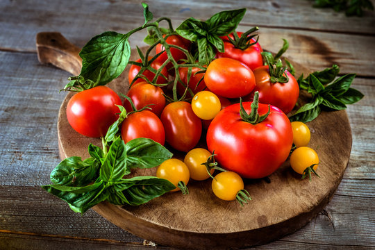Different Kind Tomatoes On Wooden Background