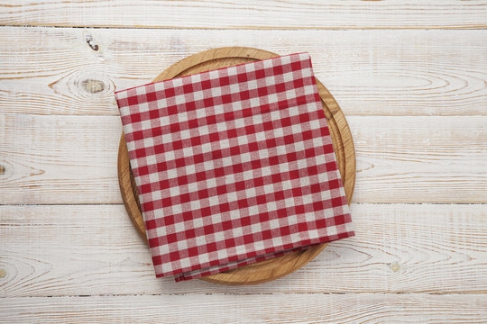 Napkin. Stack of colorful dish towels on white wooden table background top view