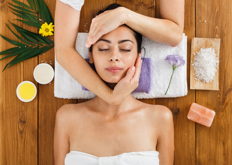 Woman massagist make face lifting massage in spa wellness center