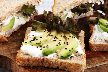 Sandwich with avocado and sesame - healthy breakfast concept