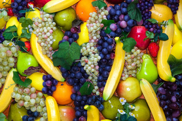 Colofrul background of different fruits - bananas, grapes, apples, oranges