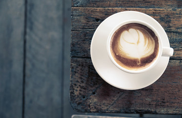 Hot coffee latte on wooden table morning.with space for your text