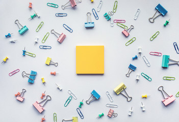 Notepad with set of colorful paper clips on white background.business creativity concept.Flat lay design.